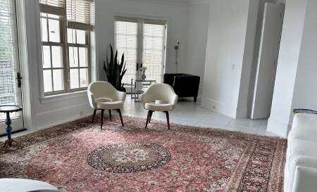 New Project - 2025-02-11T170252.674 A man installs a towel rack in a modern bathroom with gray tile walls.
