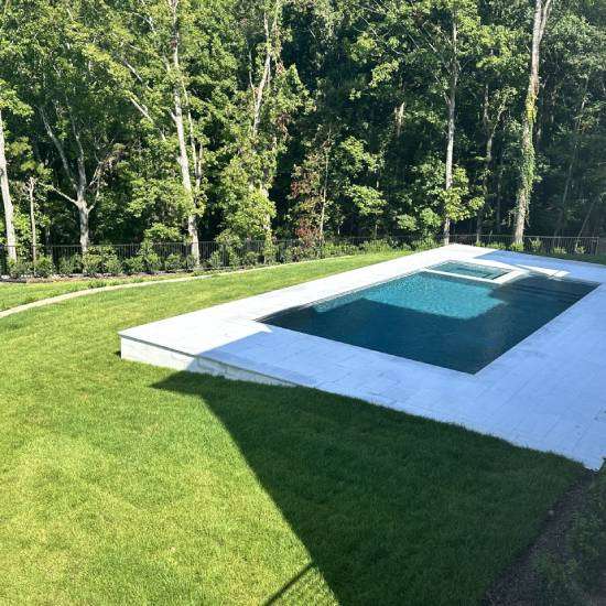 New Project - 2025-02-11T170414.690 Partially built bathroom with exposed wooden framing and piping, featuring a bathtub with some water inside.